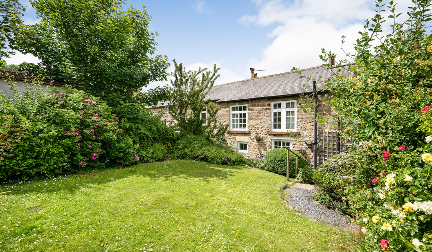 lawned garden with bushes and shrubs
